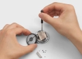 Hands disassembling a Google Pixel Watch 4 with a screwdriver to replace its battery, showing the watch's serviceable design