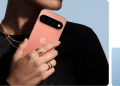 Google Pixel 11 Pro in Canyon held in hand, showing the rear camera bar with the 5x telephoto lens