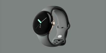 Original Google Pixel Watch in gold with a grey band, shown against a grey background