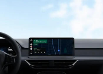 Android Auto dashboard display in a car showing Google Maps navigation and a live speedometer