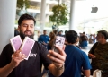 Customer holding iPhone 18 Pro purchases outside Apple BKC store in Mumbai