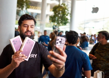 Customer holding iPhone 18 Pro purchases outside Apple BKC store in Mumbai