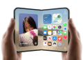 iPhone Duo unfolded in a person's hands, showing the home screen and widgets