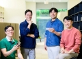Samsung Gallery Experience team members holding Galaxy phones, official Samsung Newsroom photo