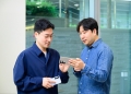 Samsung Gallery team holding Galaxy S25-series phones with visible rear camera modules