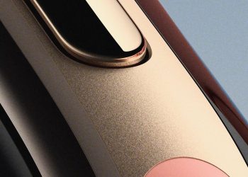 Close-up teaser image of the Fitbit Edge showing its rose-gold metal trim and band edge