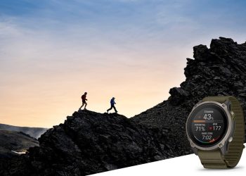 Garmin Enduro 4 on an olive ComfortFit band showing the Stamina widget against a mountain ridgeline