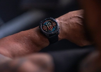 Garmin Fenix 8 AMOLED smartwatch on a wrist showing orange and teal data fields