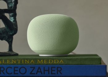 Google Home Speaker in light green sitting on a stack of books