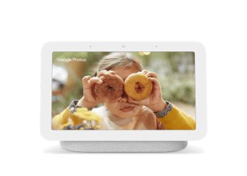 Google Nest Hub smart display in light grey showing a photo slideshow