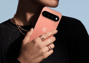 Person holding a coral Google Pixel 11 Pro showing its rear camera bar