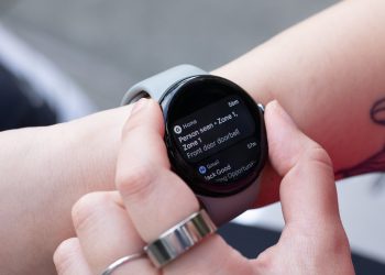 Google Pixel Watch 3 on a wrist showing stacked notifications, the model losing free Safety Signal access