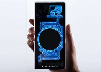 RedMagic 12 Pro+ held in a hand with its back panel lit in blue showing the RGB water cooling loop